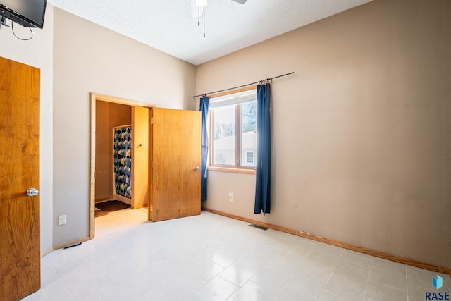 unfurnished bedroom with visible vents, a ceiling fan, and tile patterned floors