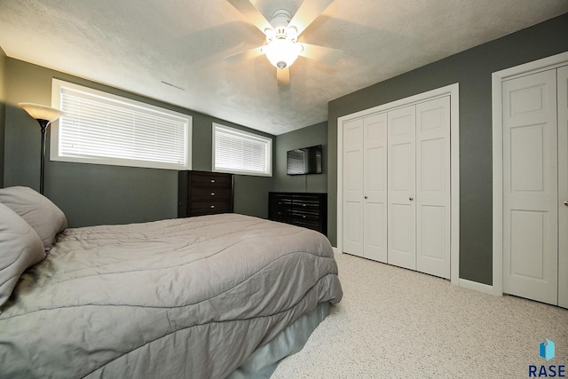 bedroom featuring ceiling fan, a textured ceiling, and carpet flooring