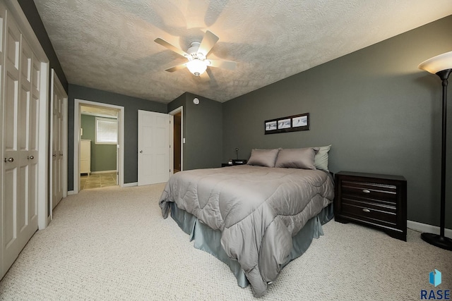 bedroom featuring a ceiling fan, carpet flooring, a textured ceiling, and baseboards