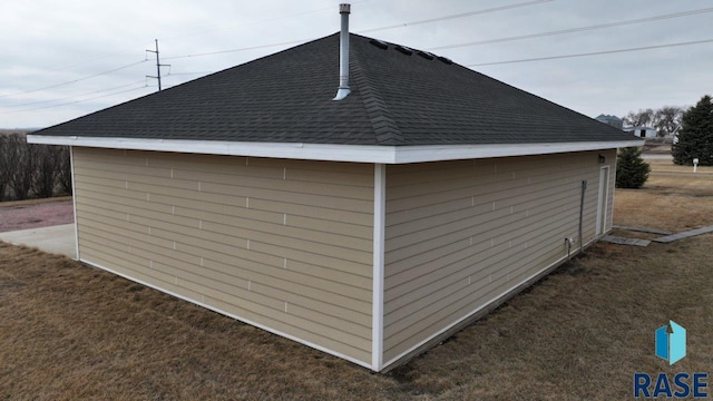 view of property exterior with roof with shingles