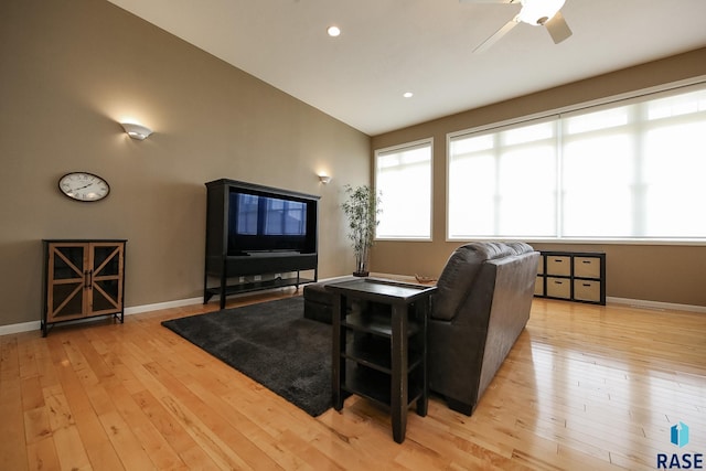 living area with light wood-style flooring and baseboards