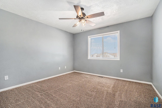 empty room with visible vents, baseboards, a ceiling fan, a textured ceiling, and carpet flooring