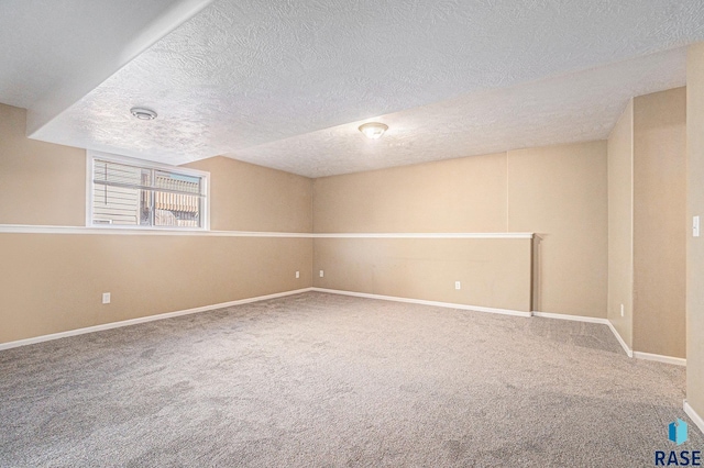 unfurnished room featuring a textured ceiling, carpet, and baseboards