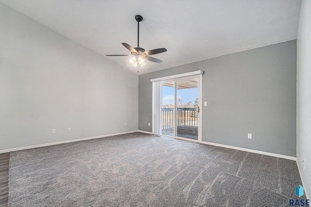 empty room with lofted ceiling, baseboards, dark carpet, and a ceiling fan