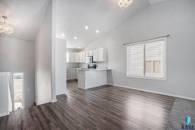 kitchen featuring a chandelier, appliances with stainless steel finishes, dark wood-type flooring, and white cabinets