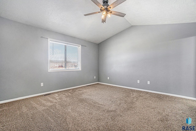 unfurnished room featuring baseboards, visible vents, a ceiling fan, lofted ceiling, and carpet floors