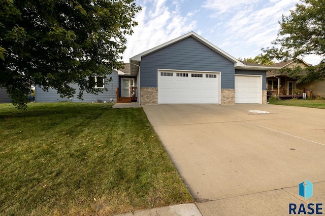 single story home featuring an attached garage, brick siding, driveway, and a front lawn