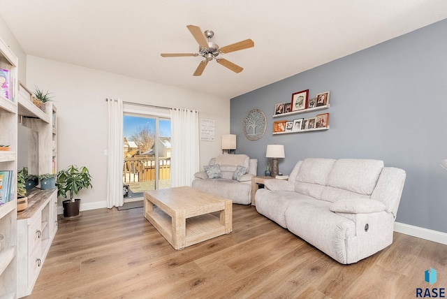 living room with ceiling fan, light wood-type flooring, and baseboards