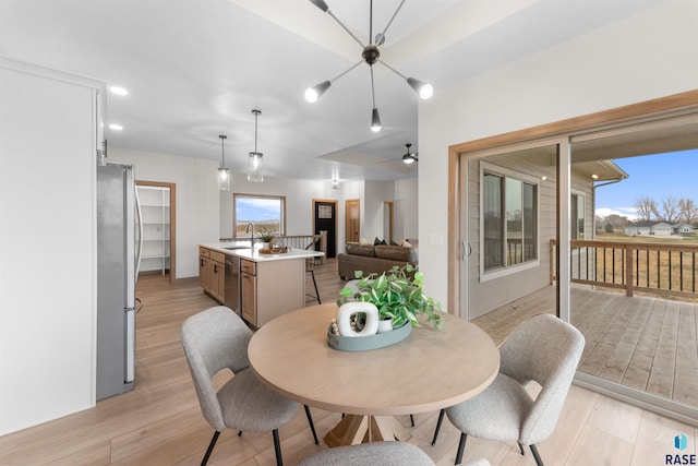 dining room featuring light wood-style flooring, a ceiling fan, and recessed lighting