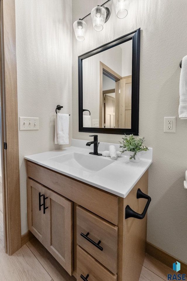 bathroom with vanity and baseboards