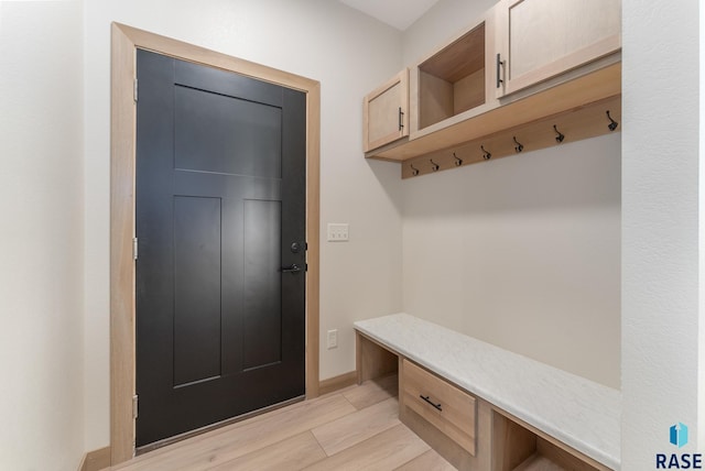 mudroom with light wood-style flooring and baseboards