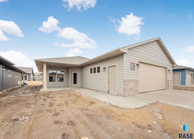 ranch-style home featuring a garage and driveway