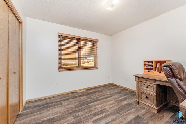 office space with a textured ceiling, wood finished floors, and baseboards