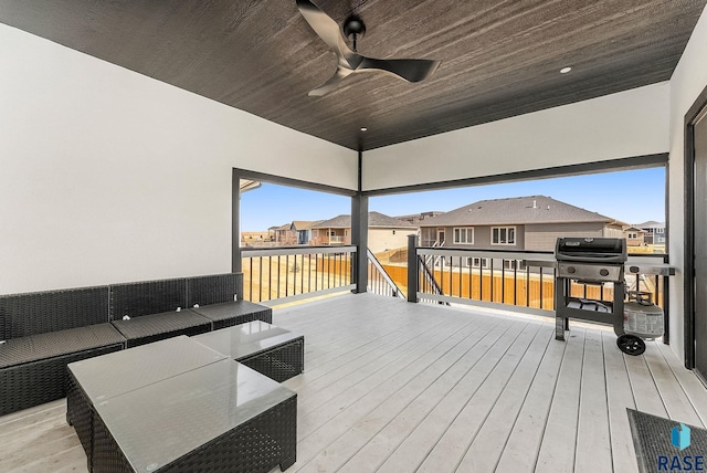 wooden terrace with a ceiling fan and a residential view