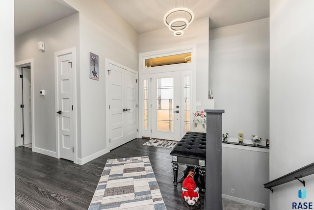 entryway with dark wood-style flooring and baseboards