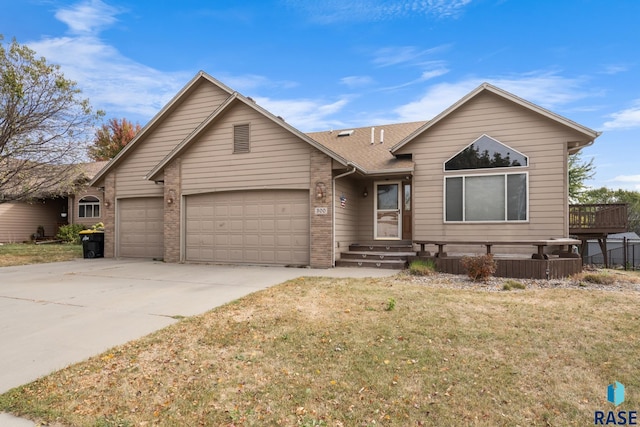 ranch-style home with an attached garage, brick siding, concrete driveway, roof with shingles, and a front lawn