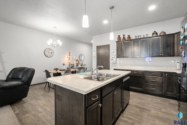 kitchen featuring light countertops, a sink, light wood finished floors, and dishwasher