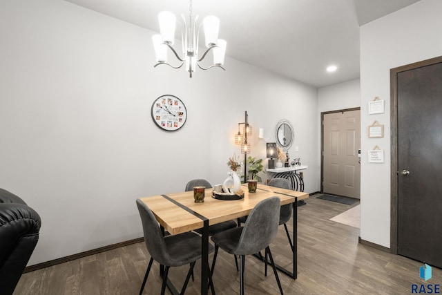 dining space featuring a chandelier, recessed lighting, baseboards, and wood finished floors