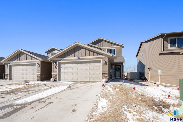 craftsman-style home featuring a garage, stone siding, board and batten siding, and concrete driveway