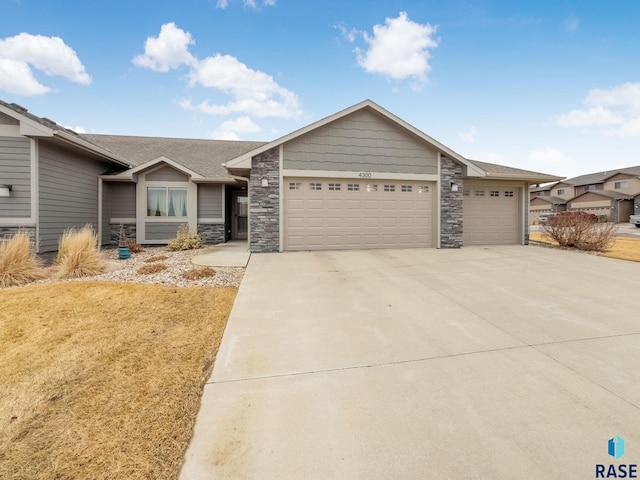 view of front of property with a garage, stone siding, driveway, and a shingled roof