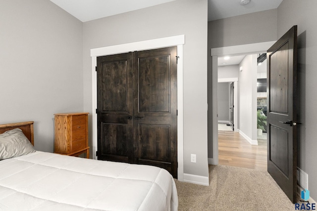 bedroom featuring carpet and baseboards