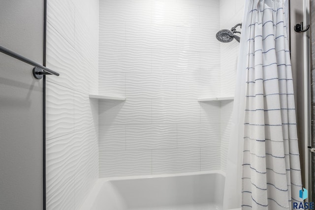 interior details featuring shower / bath combo with shower curtain