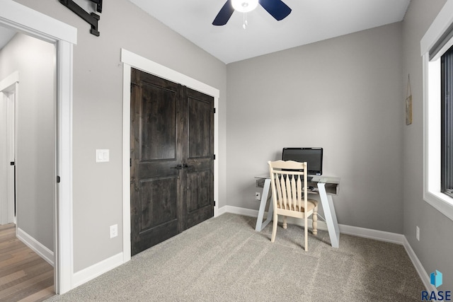 office featuring plenty of natural light, carpet, baseboards, and a ceiling fan