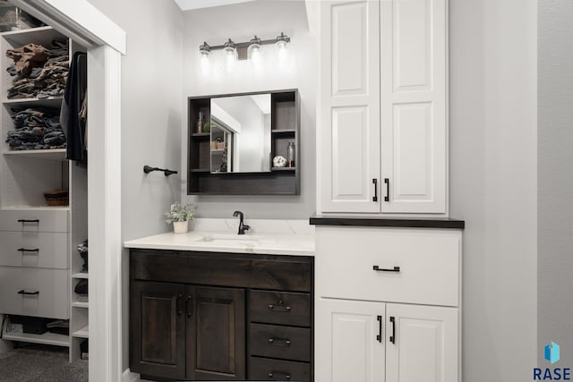 bathroom with a closet and vanity