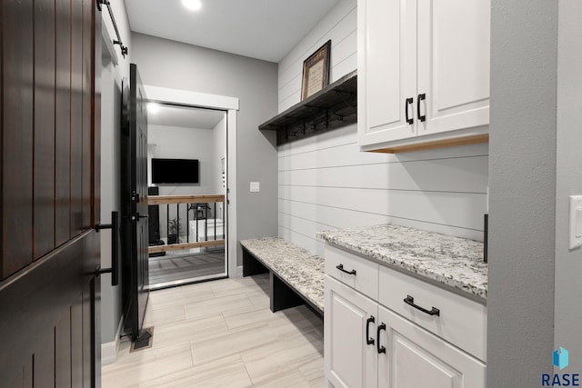 mudroom featuring a barn door