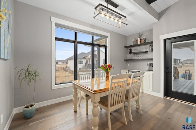 dining room featuring light wood-style floors and baseboards