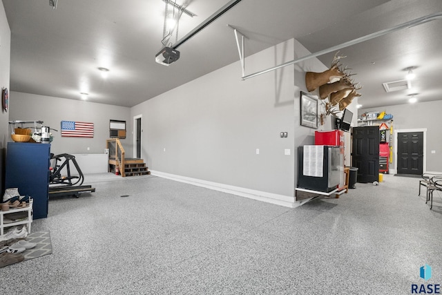 garage with baseboards and a garage door opener