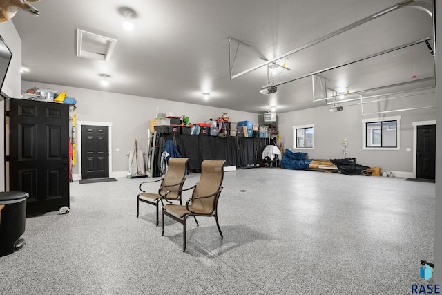 garage with baseboards and a garage door opener