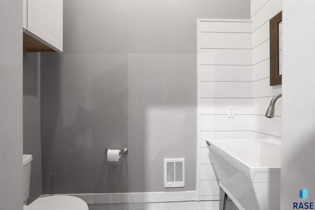 bathroom with visible vents, vanity, and toilet