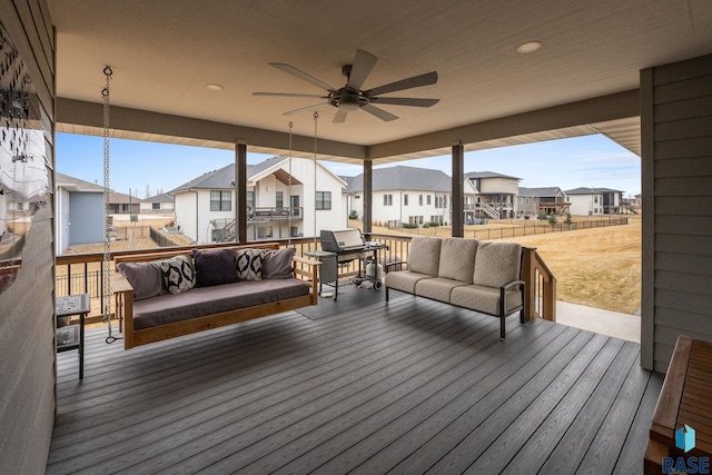 wooden deck featuring a residential view, ceiling fan, an outdoor living space, and grilling area