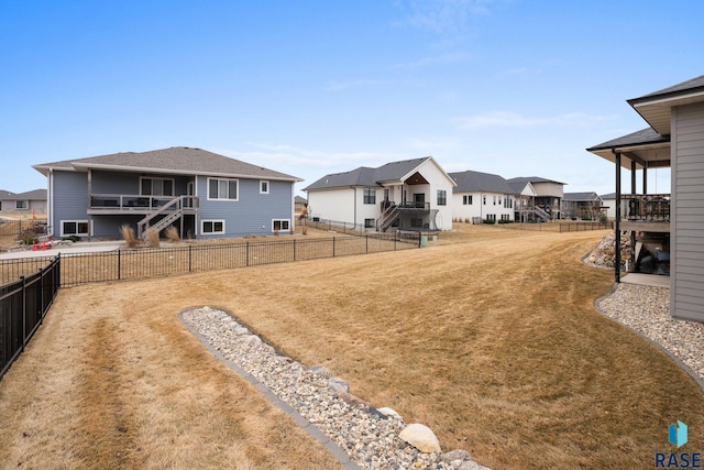 view of yard featuring a fenced backyard and a residential view