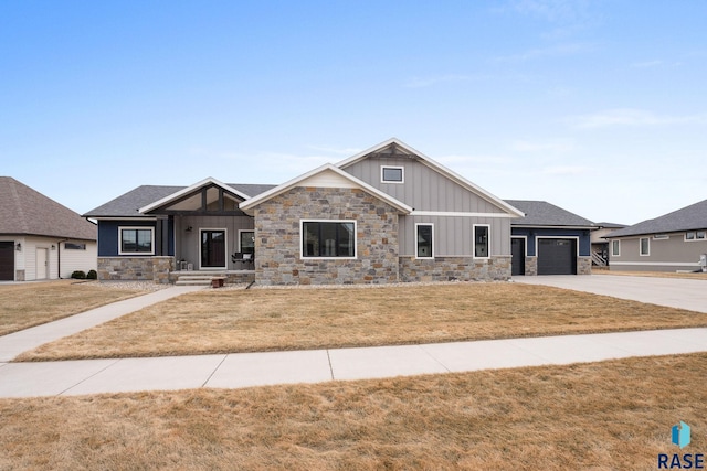 craftsman inspired home with a garage, stone siding, board and batten siding, and concrete driveway