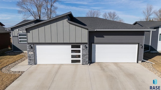 garage featuring concrete driveway