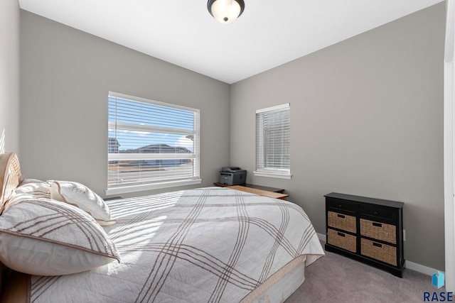 carpeted bedroom featuring baseboards