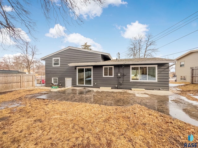 rear view of house featuring a patio area and fence