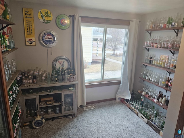 bar featuring a bar, baseboards, and visible vents