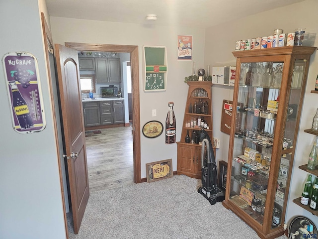 hallway featuring light colored carpet