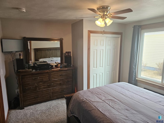 bedroom featuring carpet floors, a closet, and a ceiling fan