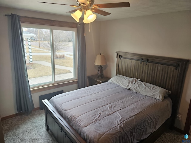 bedroom featuring carpet, multiple windows, baseboards, and ceiling fan