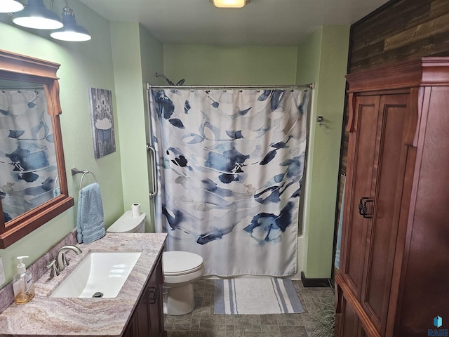 bathroom with shower / bathtub combination with curtain, vanity, and toilet