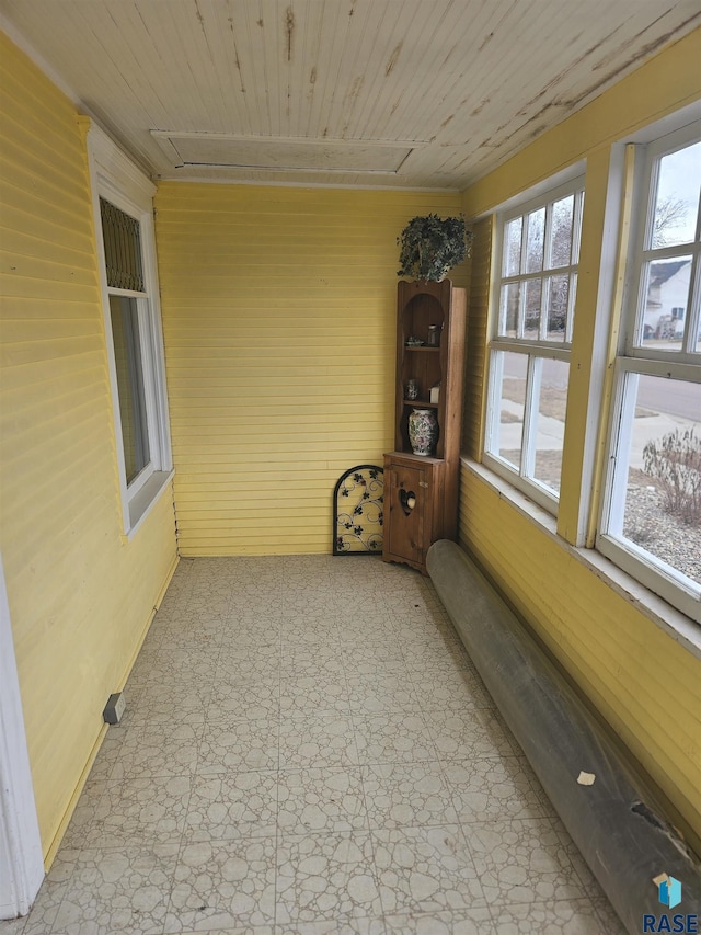 unfurnished sunroom with wood ceiling