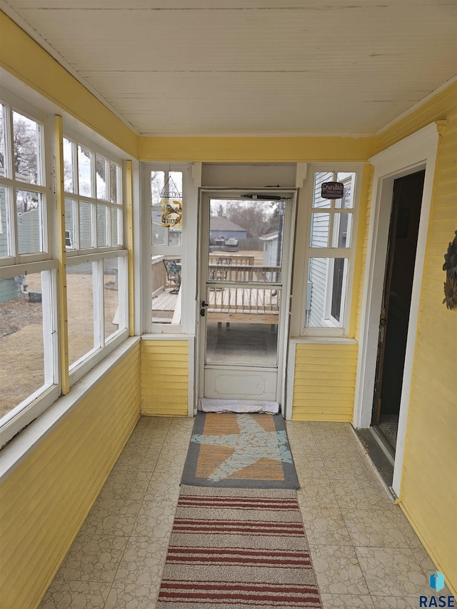 unfurnished sunroom featuring plenty of natural light