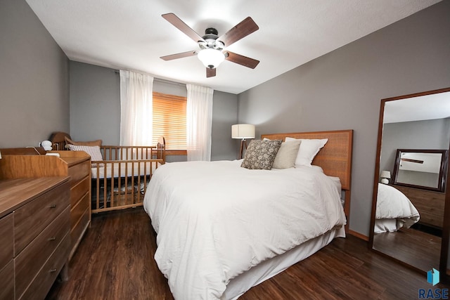 bedroom with dark wood-style floors and a ceiling fan