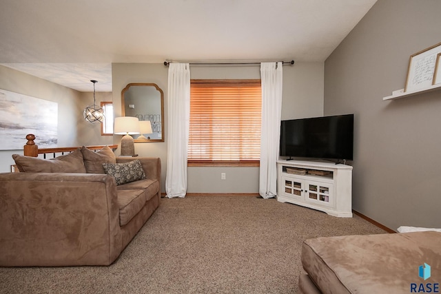 living area with carpet floors, baseboards, and an inviting chandelier