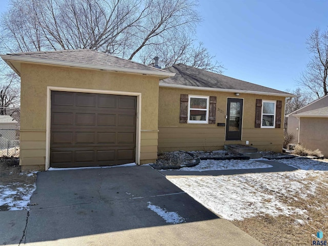 single story home with stucco siding, a shingled roof, concrete driveway, fence, and a garage