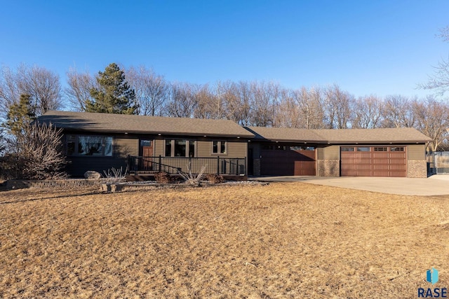 single story home featuring a garage and concrete driveway